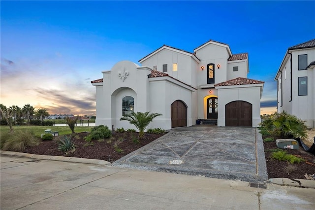 mediterranean / spanish home with a garage