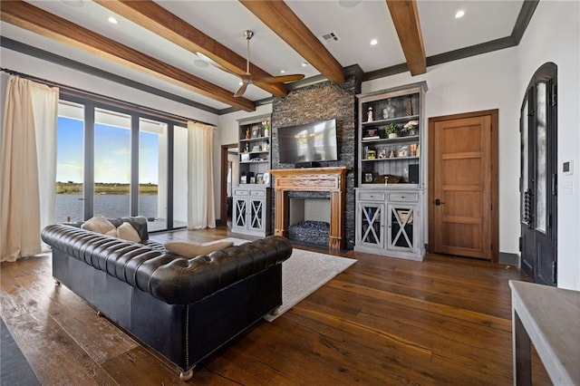 living room featuring beamed ceiling, a large fireplace, and dark hardwood / wood-style flooring