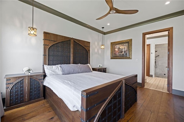 bedroom featuring ceiling fan, ornamental molding, and dark hardwood / wood-style floors