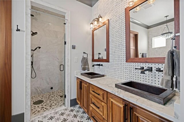 bathroom featuring vanity, decorative backsplash, an enclosed shower, and a notable chandelier