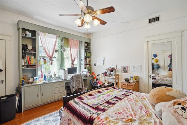 bedroom with ceiling fan and light wood-type flooring