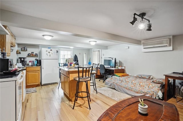 kitchen featuring a kitchen bar, white appliances, light hardwood / wood-style flooring, an AC wall unit, and a center island