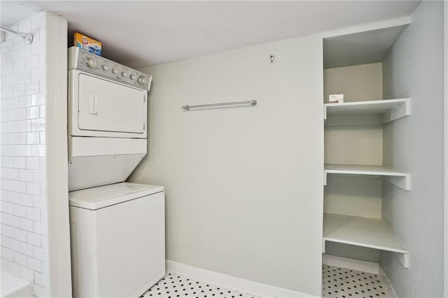 washroom featuring stacked washer and clothes dryer