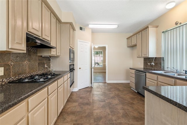 kitchen with light brown cabinets, sink, a textured ceiling, appliances with stainless steel finishes, and tasteful backsplash