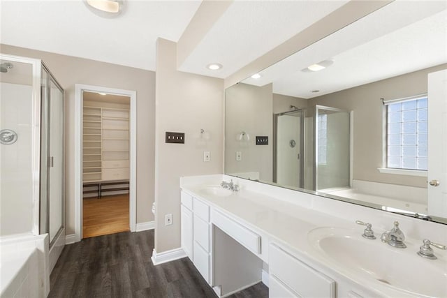 bathroom featuring vanity, separate shower and tub, and wood-type flooring