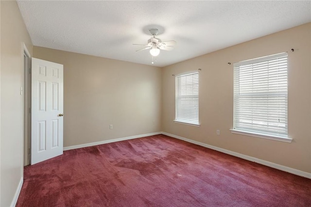 carpeted spare room featuring ceiling fan and a textured ceiling