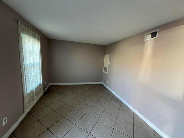 unfurnished room with light tile patterned floors