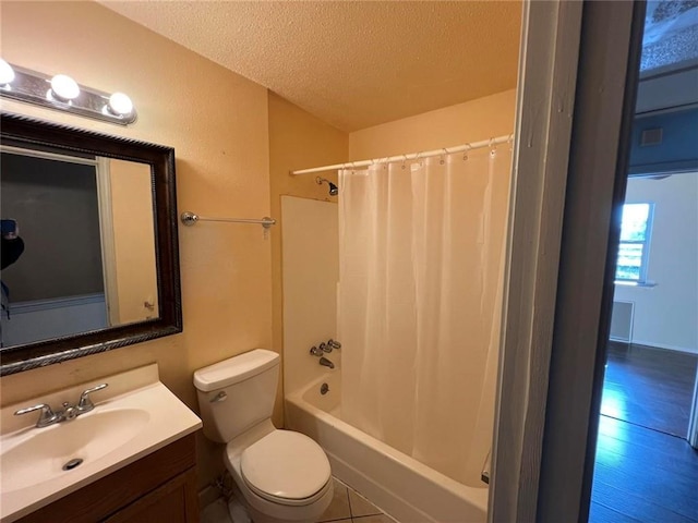 full bathroom featuring hardwood / wood-style floors, a textured ceiling, toilet, shower / bath combo with shower curtain, and vanity