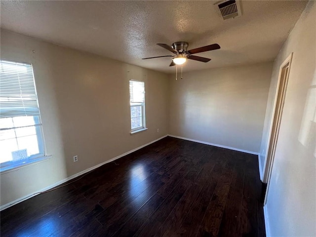 spare room featuring a textured ceiling, dark hardwood / wood-style floors, and ceiling fan