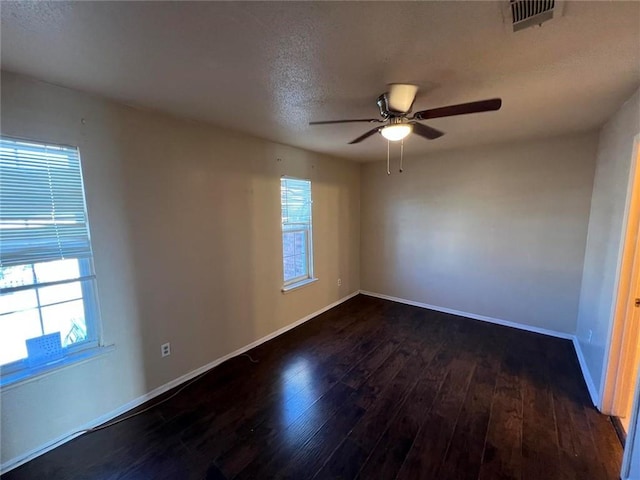 unfurnished room with ceiling fan and dark wood-type flooring