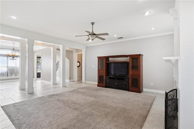 unfurnished living room with ceiling fan with notable chandelier, ornamental molding, and decorative columns