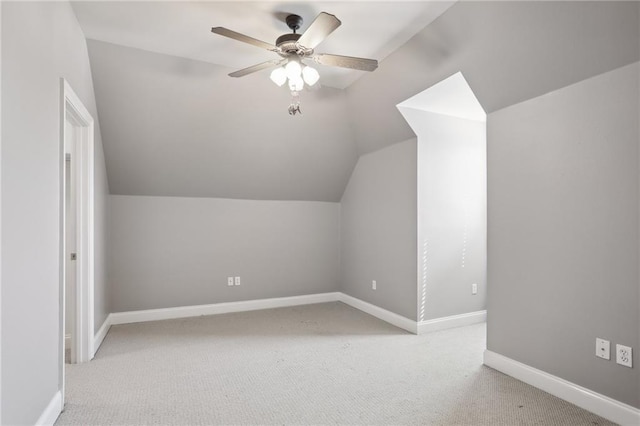 additional living space with ceiling fan, light carpet, and vaulted ceiling