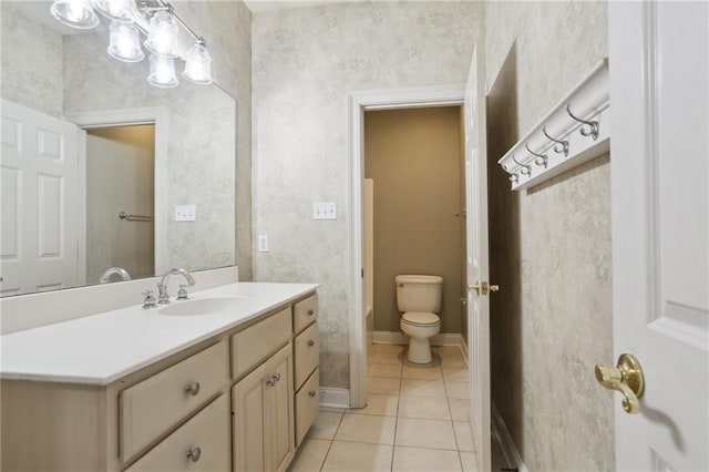 bathroom featuring tile patterned floors, vanity, and toilet