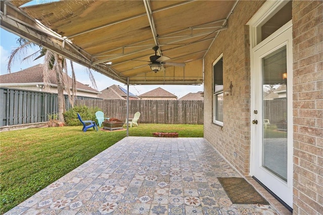 view of patio featuring a fire pit and ceiling fan