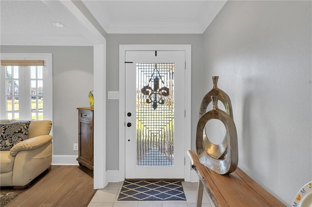 foyer featuring light tile patterned floors and ornamental molding