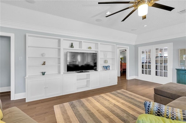 living room featuring a textured ceiling, ceiling fan, and dark wood-type flooring