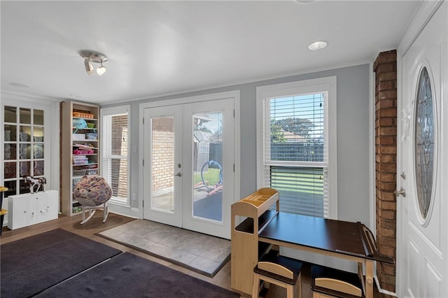 entryway with crown molding, french doors, and hardwood / wood-style floors