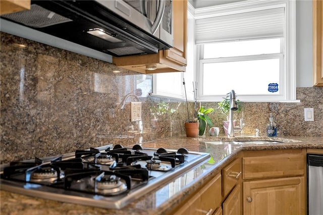 kitchen featuring stone counters, tasteful backsplash, stainless steel appliances, and sink