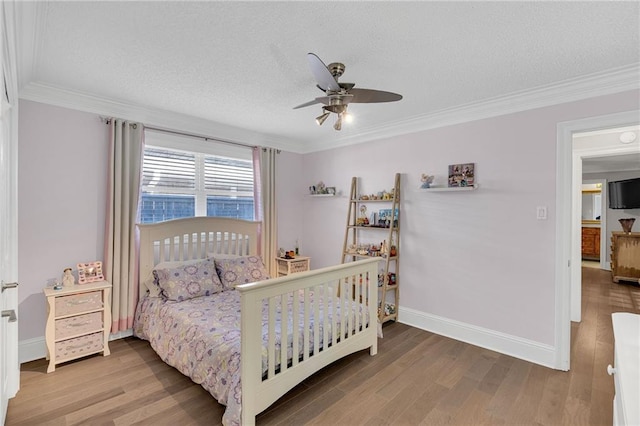 bedroom with a textured ceiling, ceiling fan, wood-type flooring, and ornamental molding