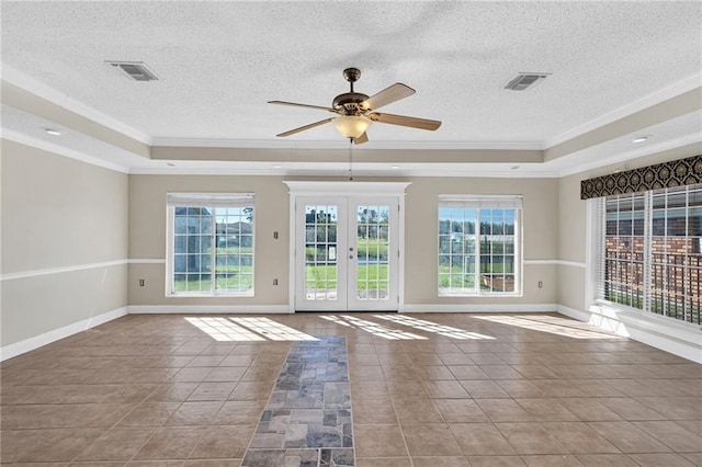 spare room featuring a raised ceiling, a textured ceiling, and ornamental molding