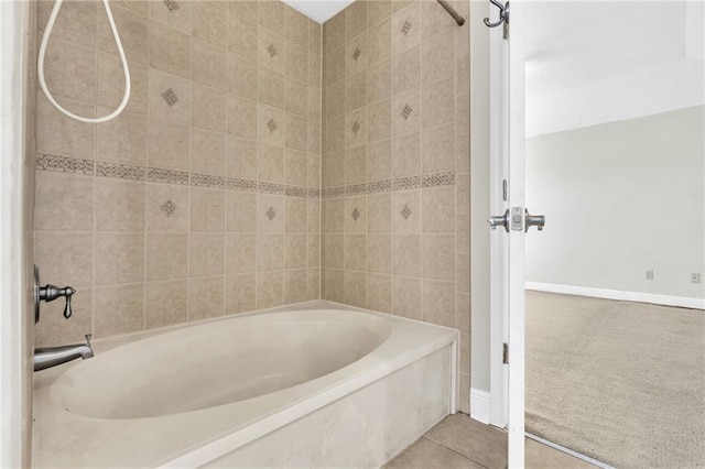 bathroom featuring tiled shower / bath combo and tile patterned floors