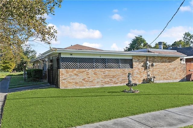 view of side of property with a yard