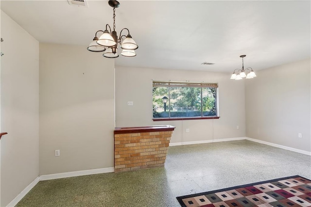 spare room featuring an inviting chandelier