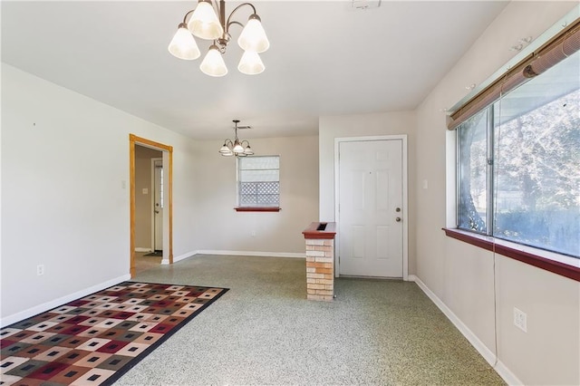 entryway with a chandelier