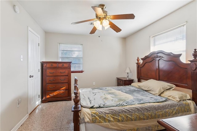 bedroom with multiple windows and ceiling fan