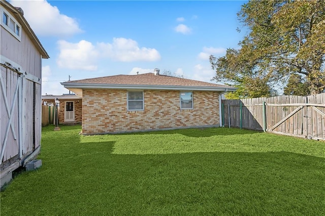 rear view of house featuring a lawn