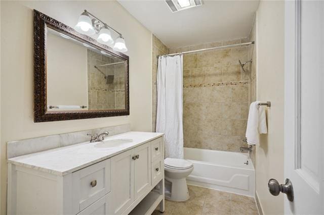 full bathroom featuring tile patterned floors, vanity, shower / tub combo, and toilet