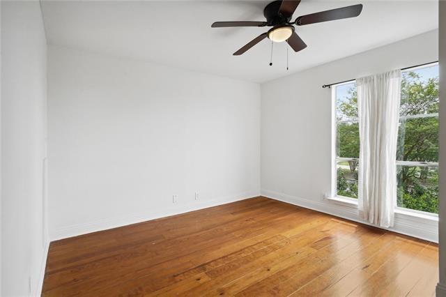 empty room featuring ceiling fan and hardwood / wood-style flooring