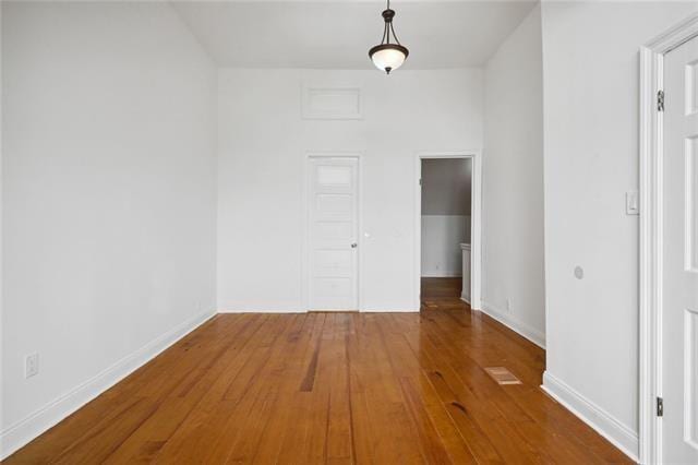 empty room with hardwood / wood-style flooring