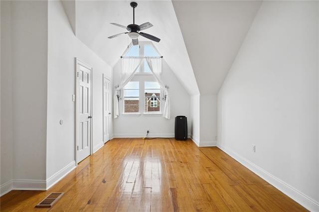 bonus room with hardwood / wood-style floors, ceiling fan, and lofted ceiling