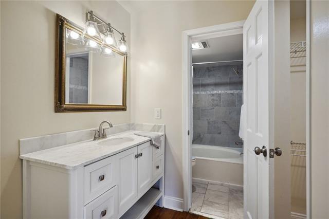 full bathroom featuring vanity, toilet, and tiled shower / bath