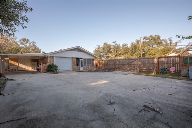 view of property exterior with a garage and a carport