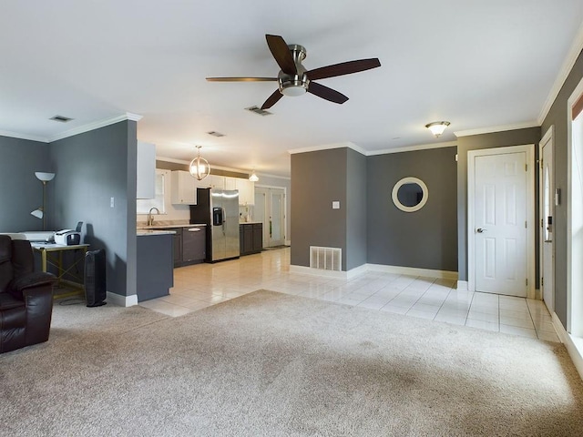 tiled living room with ceiling fan, sink, and ornamental molding