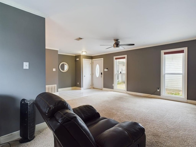 living room featuring ceiling fan, crown molding, and light carpet