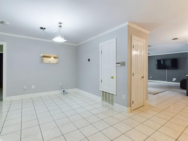 tiled empty room featuring crown molding