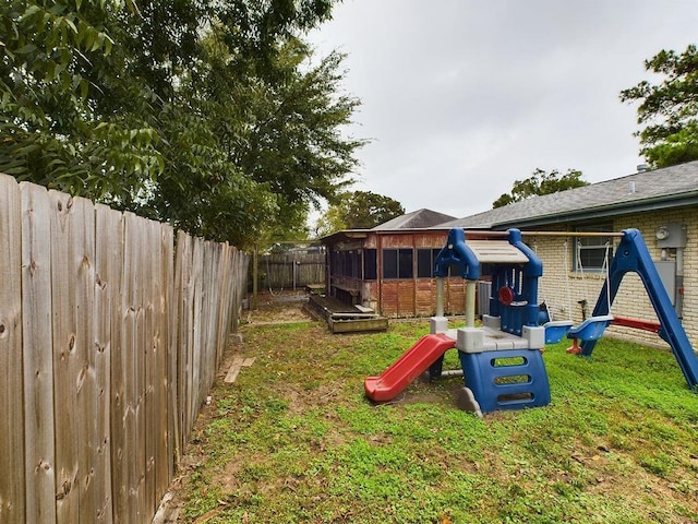 view of playground with a lawn