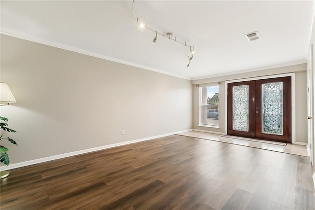 foyer entrance with french doors, wood-type flooring, track lighting, and ornamental molding