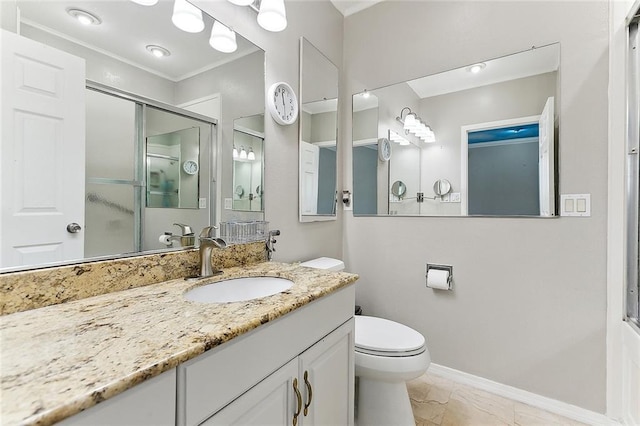 bathroom featuring vanity, toilet, and an enclosed shower