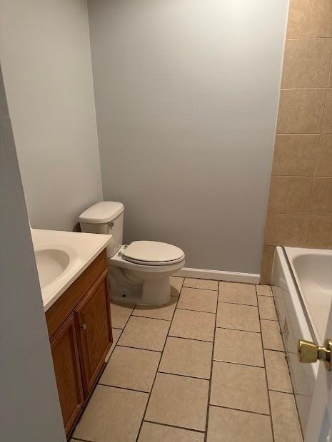1300 Bolo Ct, Bridge City, LA 70094 - bathroom with tile patterned flooring, a bath, vanity, and toilet