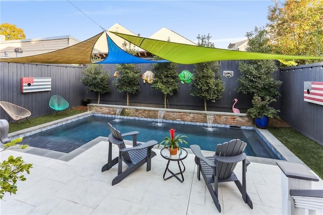 view of swimming pool featuring pool water feature and a patio