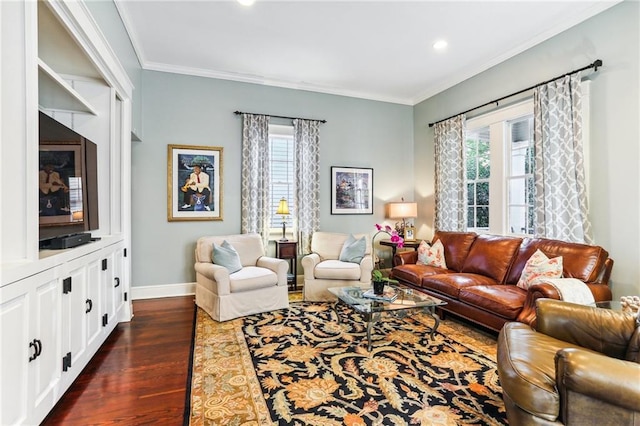 living room with dark hardwood / wood-style flooring, a wealth of natural light, and crown molding