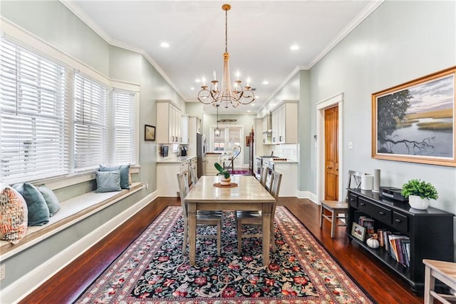 dining space with dark hardwood / wood-style floors, an inviting chandelier, and ornamental molding