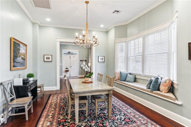 dining room with dark wood-type flooring, a notable chandelier, and ornamental molding