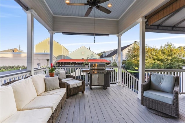 wooden terrace featuring grilling area and an outdoor hangout area