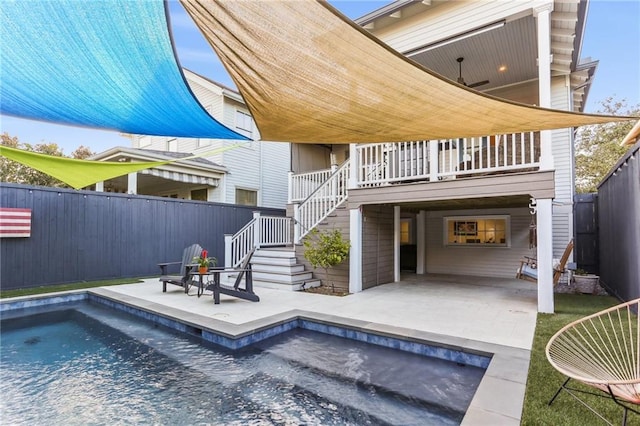 back of house featuring a fenced in pool and a patio