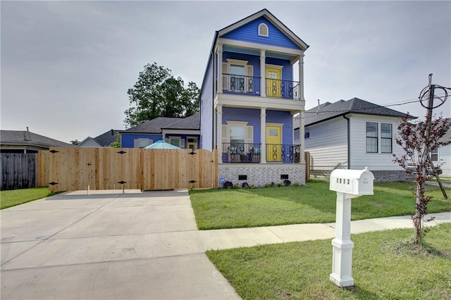 view of front of property with a balcony and a front lawn